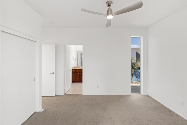 spare room with ceiling fan, light colored carpet, and plenty of natural light