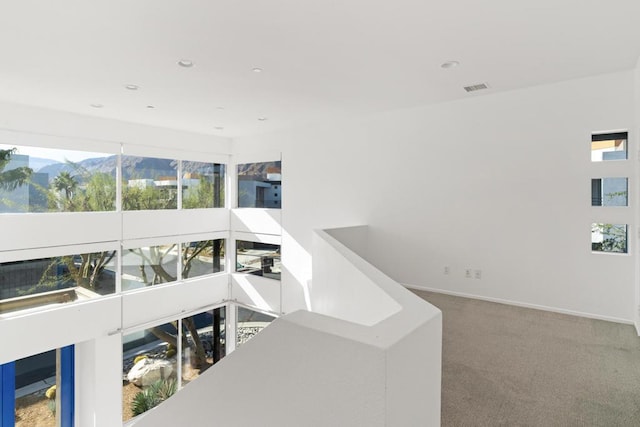 interior space with a mountain view and carpet floors