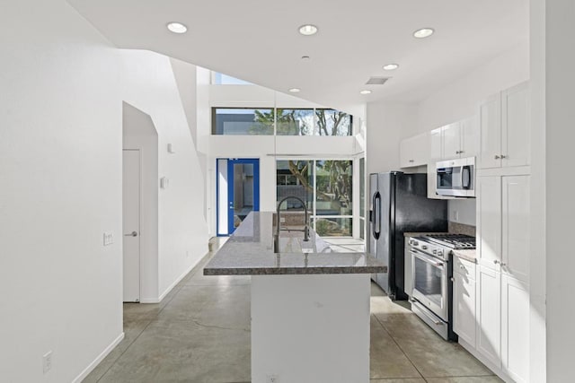 kitchen with white cabinets, sink, an island with sink, and stainless steel appliances