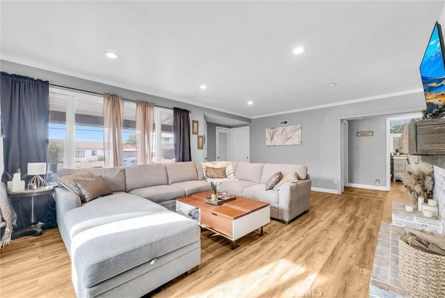 living room with light hardwood / wood-style flooring and ornamental molding