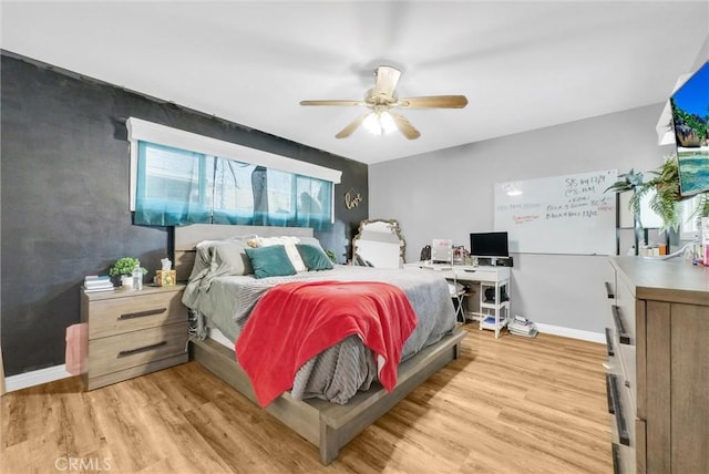 bedroom with ceiling fan and light hardwood / wood-style floors