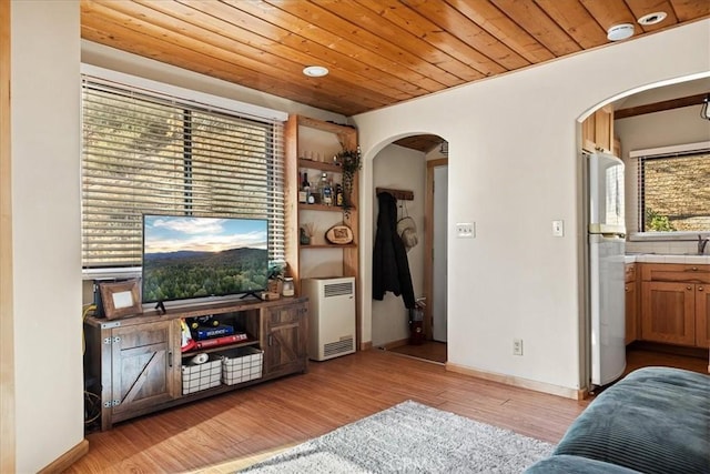 living room featuring sink, wood ceiling, and light wood-type flooring