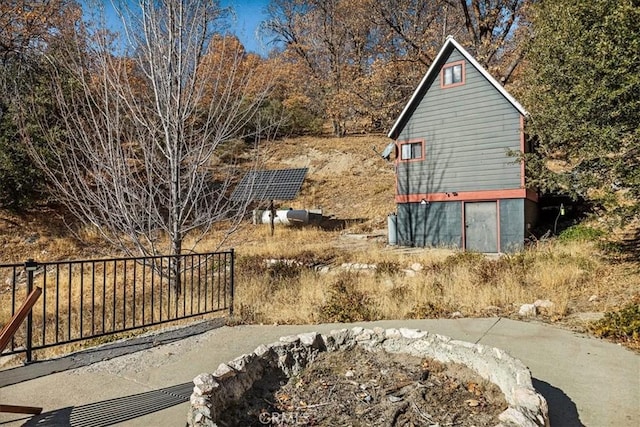 view of side of home with an outdoor fire pit