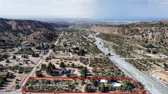 birds eye view of property with a mountain view