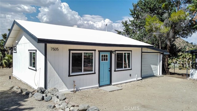 rear view of house featuring a garage