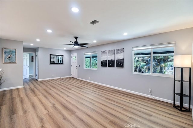 unfurnished living room with light wood-type flooring and ceiling fan