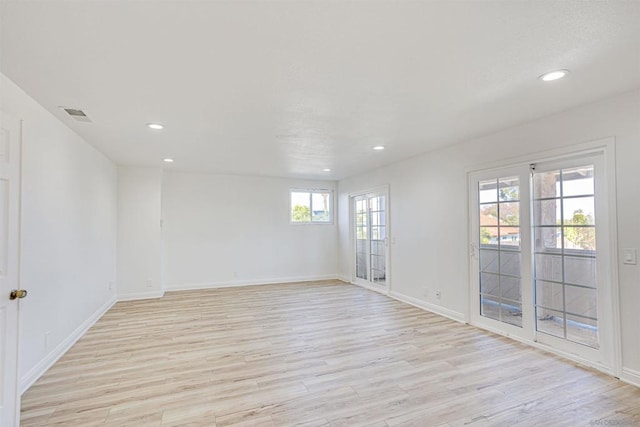 spare room featuring light hardwood / wood-style flooring