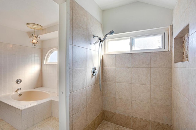 bathroom with a tile shower and a chandelier