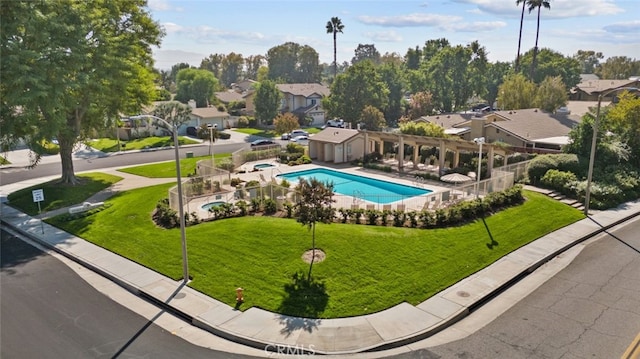 view of pool featuring a patio area and a yard