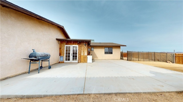 rear view of property with french doors and a patio