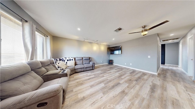 living room with ceiling fan and light wood-type flooring