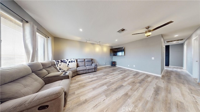 living room with ceiling fan and light hardwood / wood-style floors