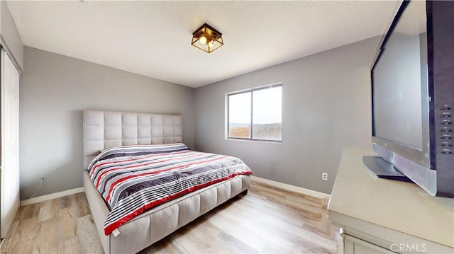 bedroom with light wood-type flooring