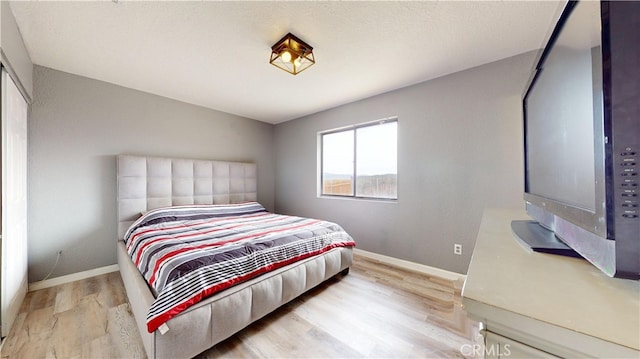 bedroom with light hardwood / wood-style floors