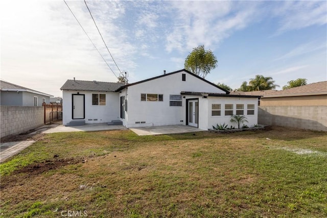 back of house featuring a yard and a patio