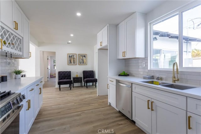 kitchen with white cabinets, a healthy amount of sunlight, sink, and appliances with stainless steel finishes