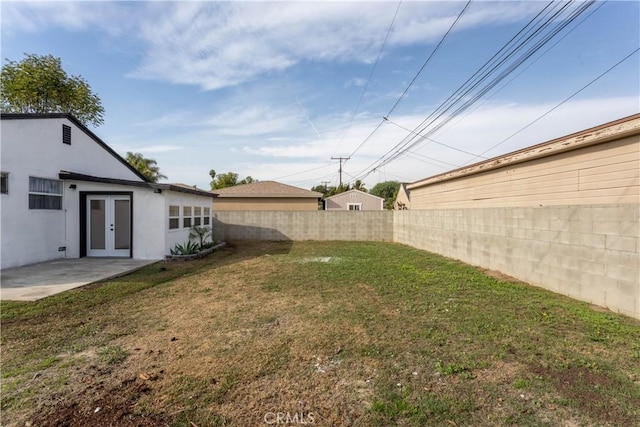 view of yard featuring a patio area and french doors