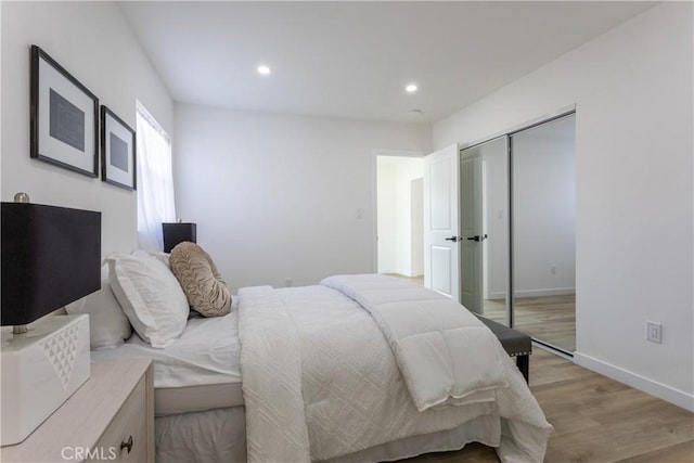 bedroom with a closet and light hardwood / wood-style flooring