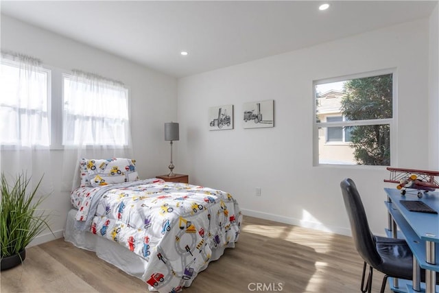 bedroom featuring light hardwood / wood-style floors and multiple windows