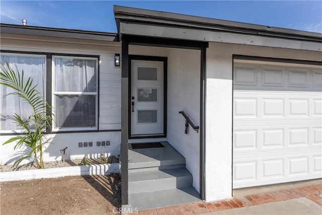 doorway to property featuring a garage