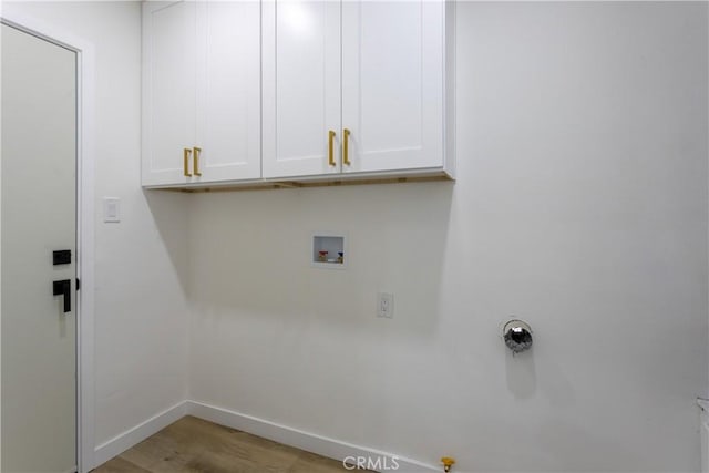 laundry room featuring light hardwood / wood-style floors, cabinets, and hookup for a washing machine