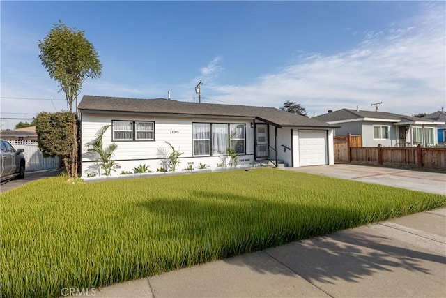 ranch-style house featuring a front yard and a garage