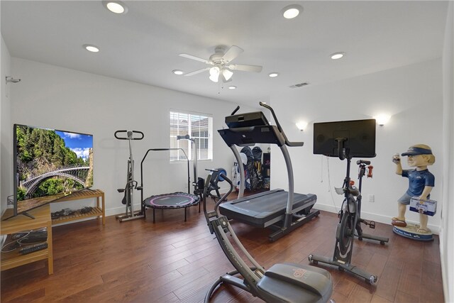 workout area featuring dark hardwood / wood-style flooring and ceiling fan