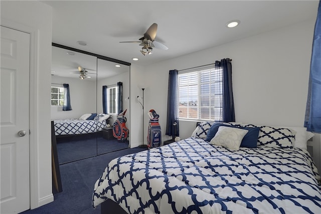 bedroom with carpet, ceiling fan, and a closet