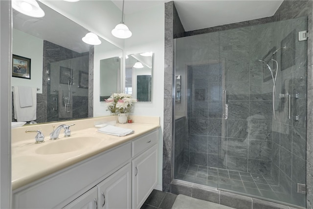 bathroom with tile patterned flooring, vanity, and a shower with shower door