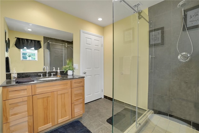 bathroom with tile patterned flooring, vanity, and an enclosed shower