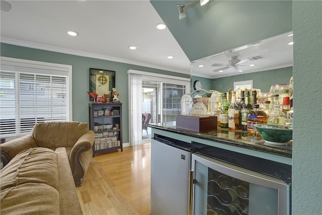 bar with light hardwood / wood-style floors, refrigerator, crown molding, and wine cooler