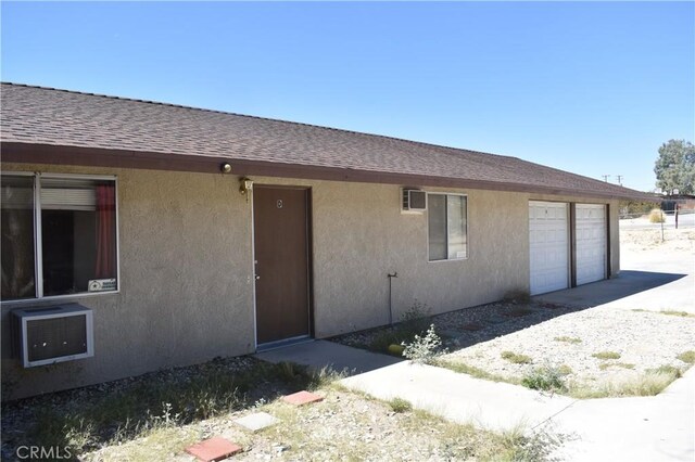 73591 Sunnyslope Dr Unit 29, Palms, CA 92277 - property entrance featuring heating unit and a garage