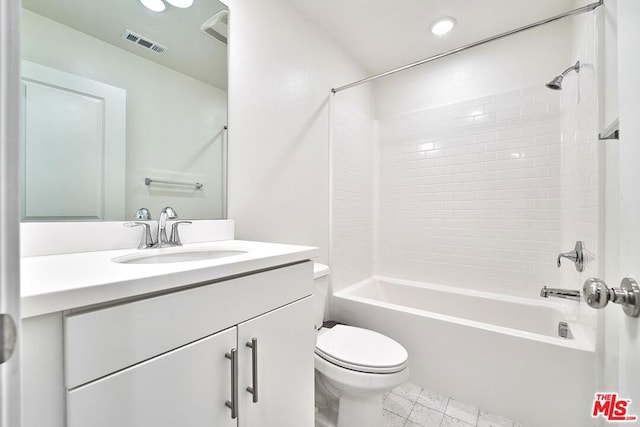 full bathroom featuring tiled shower / bath combo, toilet, and vanity