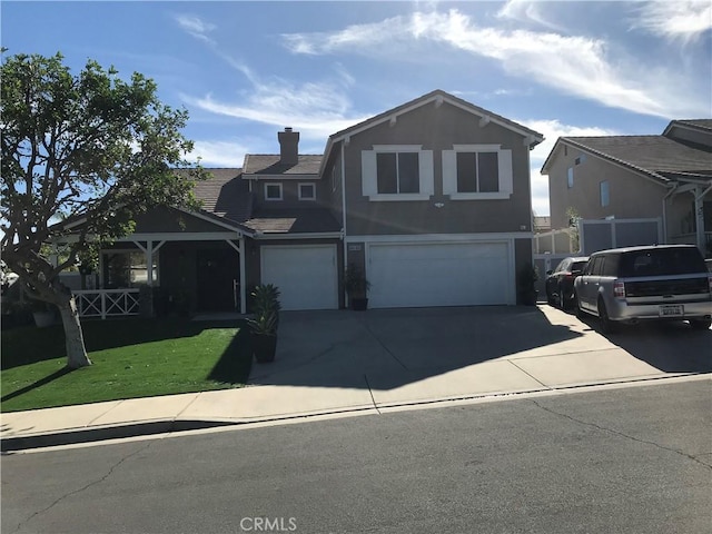 view of property with a front lawn and a garage