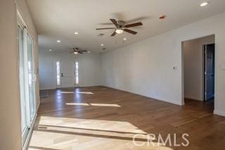 unfurnished room featuring ceiling fan and dark hardwood / wood-style flooring