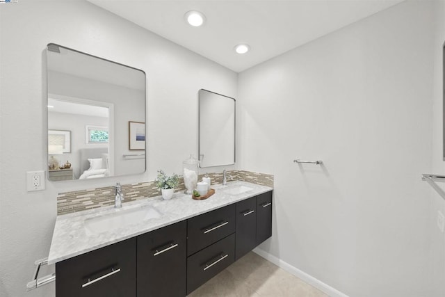 bathroom with backsplash, tile patterned floors, and vanity