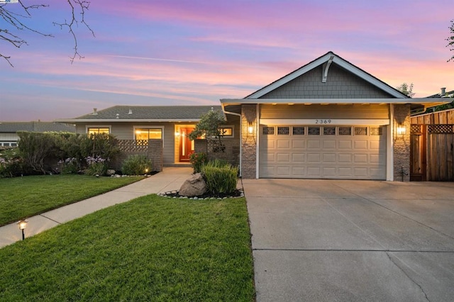 view of front of house featuring a garage and a yard