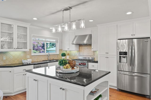 kitchen with stainless steel appliances, white cabinetry, and a center island