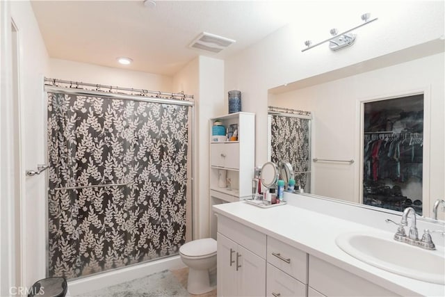 bathroom with toilet, vanity, and a shower with shower curtain