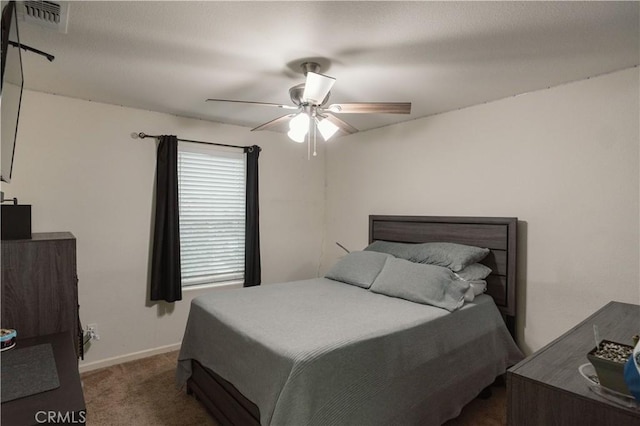 bedroom featuring ceiling fan and dark colored carpet