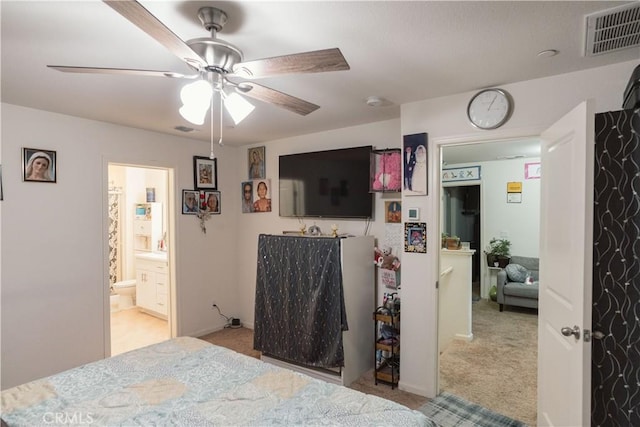 carpeted bedroom featuring ceiling fan and ensuite bathroom