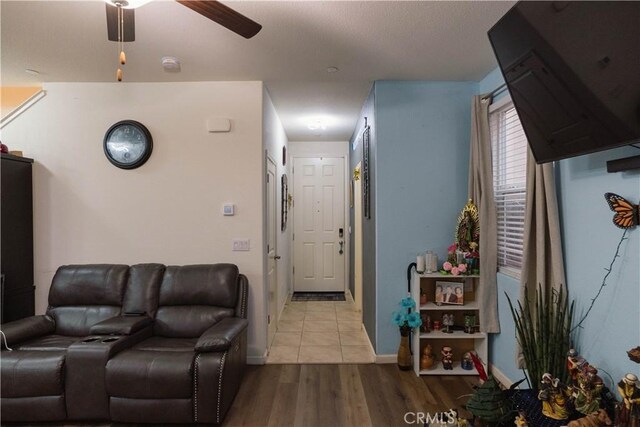 living room with ceiling fan and light hardwood / wood-style flooring