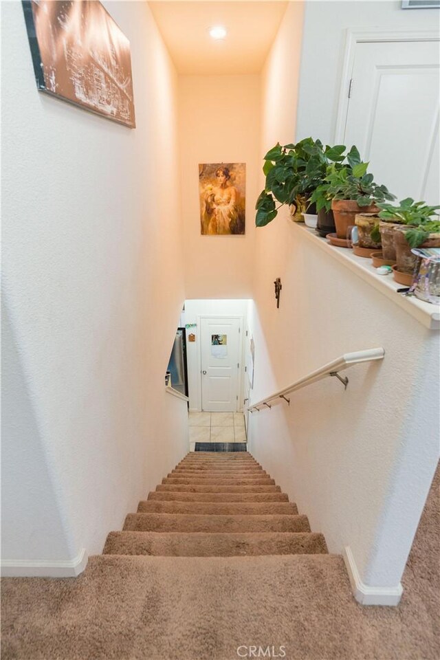 stairway with tile patterned floors