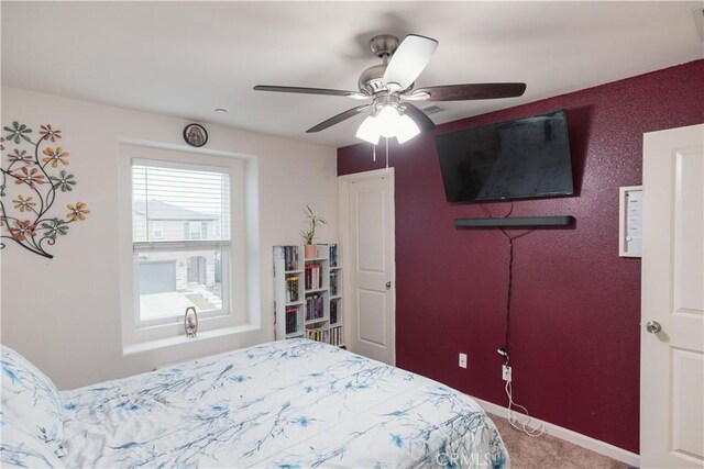 bedroom with ceiling fan and carpet flooring