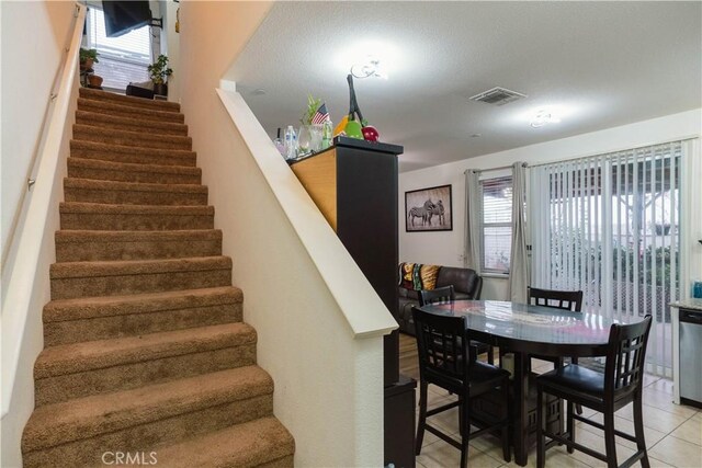 dining room featuring a wealth of natural light and light tile patterned floors