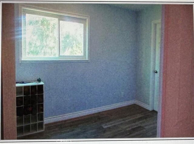 spare room featuring dark wood-type flooring