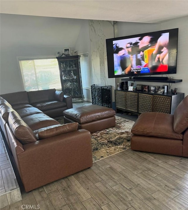 living room featuring vaulted ceiling and wood-type flooring