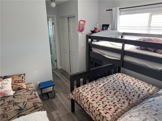 bedroom featuring a closet and dark hardwood / wood-style floors