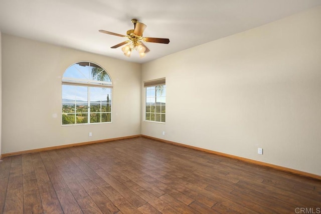 unfurnished room featuring ceiling fan and dark hardwood / wood-style flooring