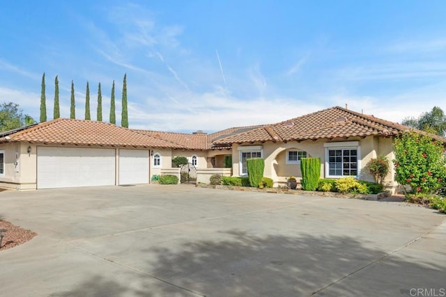 mediterranean / spanish-style house featuring a garage